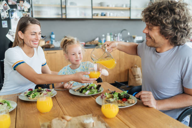 istock Happy young family eating together 1630474679
