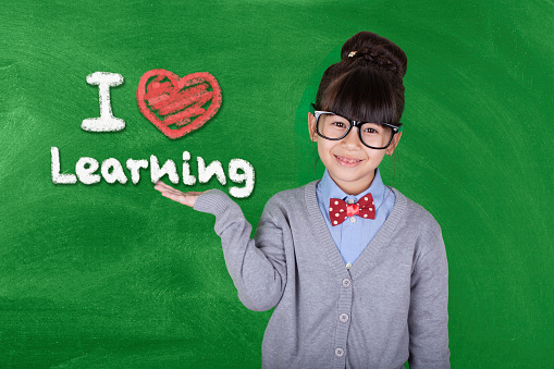 Back to school text and happy kid on chalkboard background