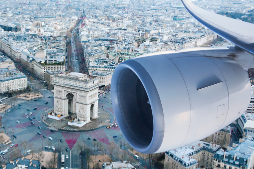 looking out to Champs-Élysées in Paris from a flying passenger plane window