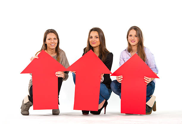 istock Three beautiful women holding arrows pointing up 163052092