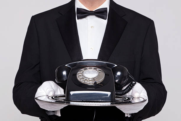 istock Butler holding a telephone on silver tray 163052707