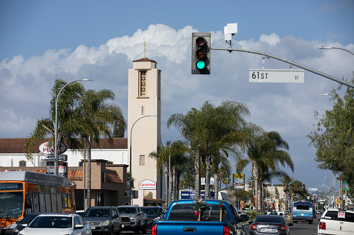 Maywood, California, USA - February 11, 2023: Afternoon traffic passes through Downtown Maywood.