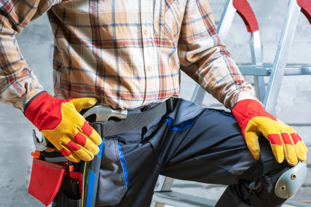 istock Handyman with a tool belt. Worker with tools against concrete wall background. 1630611023