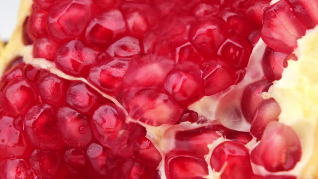 Juicy red pomegranate cut in half close up. Fresh ripe pomegranate. Ripe fruit is a healthy food.