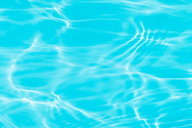 istock Blue water with ripples on the surface. Defocus blurred transparent blue colored clear calm water surface texture with splashes and bubbles. Water waves with shining pattern texture background. 1630640173