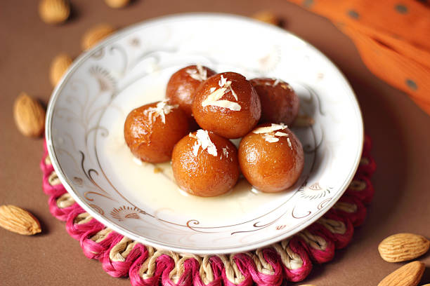 Gulab jamun Gulab jamun is very popular Indian dessert made with fresh homemade Khoya, soaked in warm sugar surup. india sweets stock pictures, royalty-free photos & images