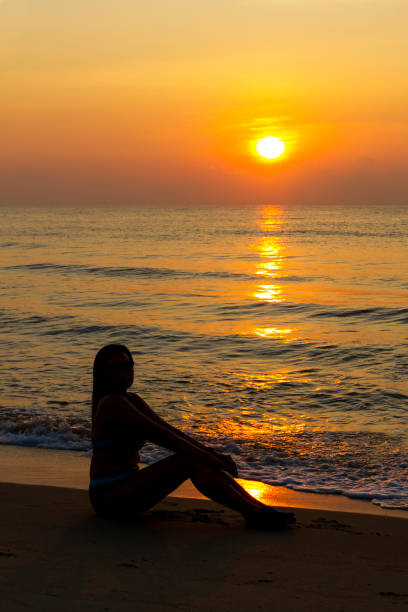 istock Woman body big with bikini and sunrise on beach 1630658002