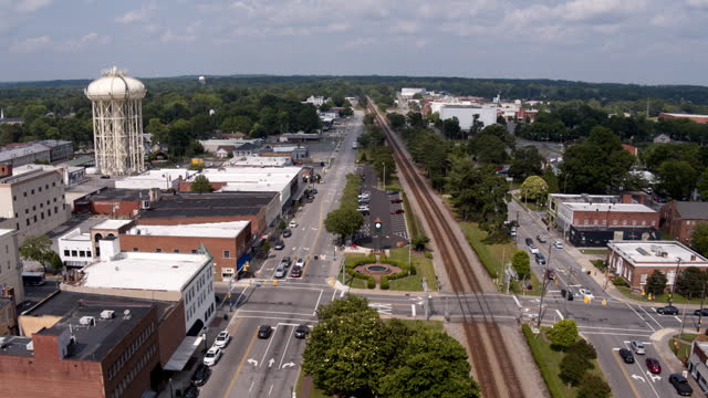 4g and 5g connection on Main Street along the railroad in Thomasville, NC. Cell Tower development of Industrial District. Aerial footage with forward-descending camera motion