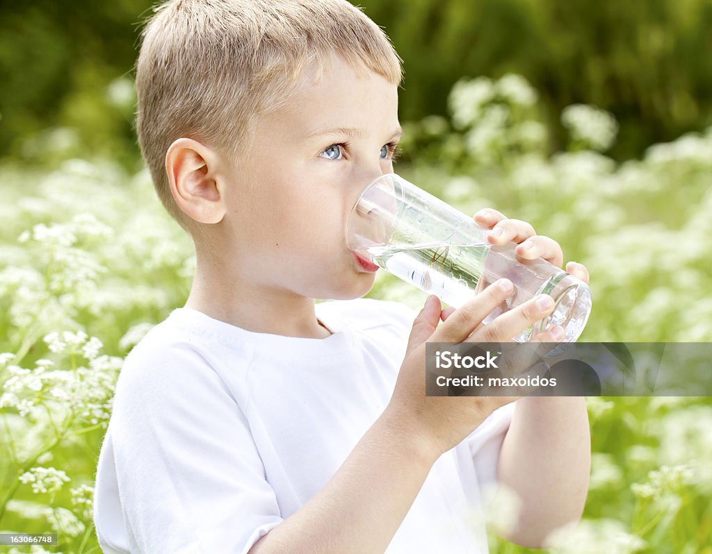 Child drinking pure water Child drinking pure water in nature Boys Stock Photo