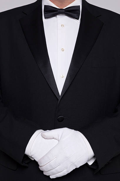 istock Man in a tuxedo wearing white gloves. 163071878