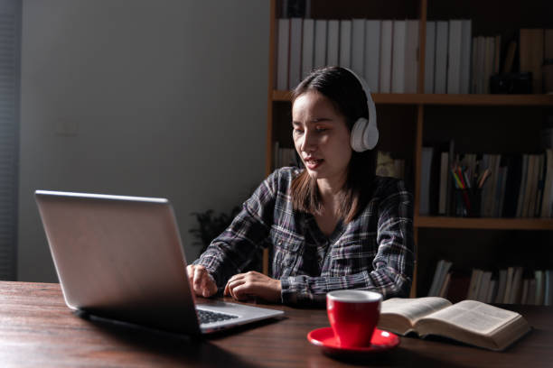 istock Christian online technology concept. Hands praying of christian with digital computer laptop, Online live church for sunday service. Asian catholic man are reading Holy bible book and online study. 1630732953