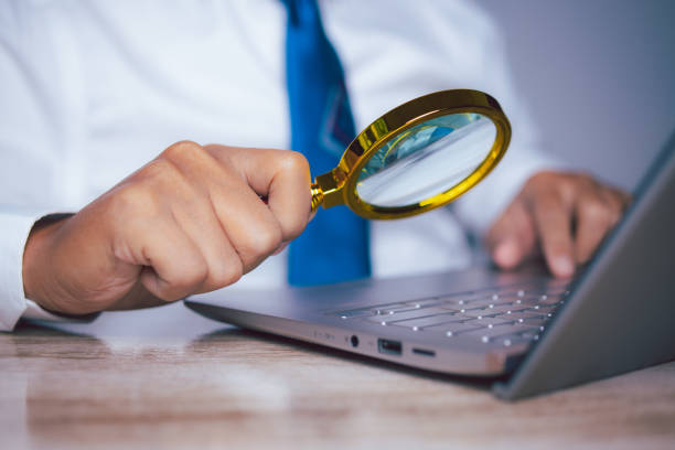 istock Businessman using magnifying glass searching data. Information in the internet world search technology Search Engine Optimization(SEO). 1630733874