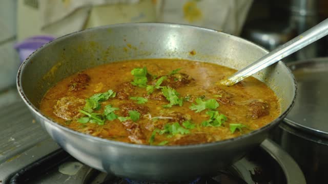 Garnishing with coriander vegetable Kofta curry in kadai which is an Indian Food, 4k footage