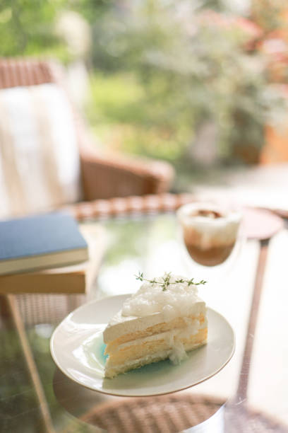 Coconut Cake and Coffee in a cafe on the blur background. traditional dessert Sliced of delicious coconut layer cake