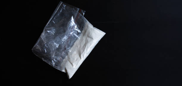 istock Cocaine in a plastic package on a black background. 1630738771