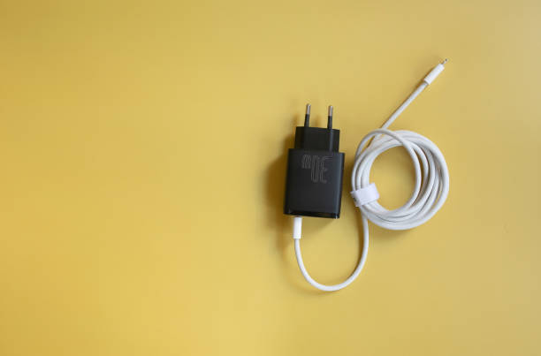 istock Phone charger and USB cable on yellow background. 1630738922