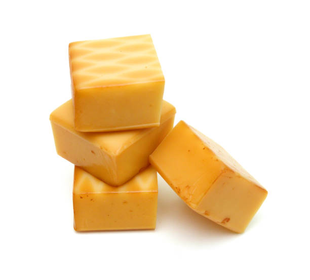 istock Cubes of cheddar cheese isolated on white 1630738975