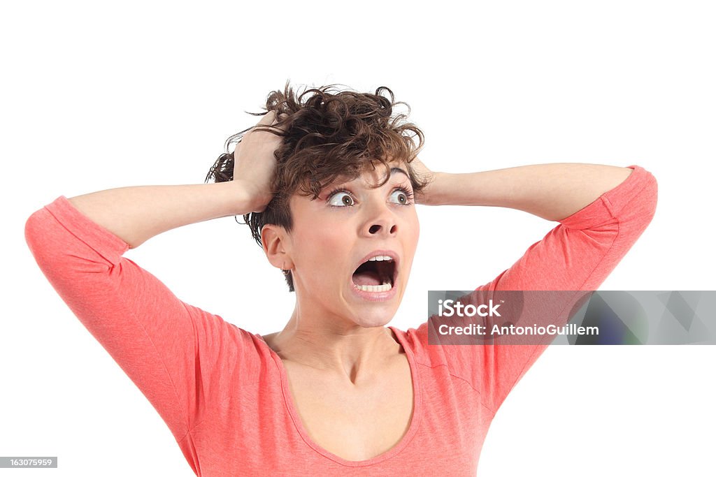 Hysterical woman expression with her hands on the head Hysterical woman expression with her hands on the head on a white isolated background Adult Stock Photo