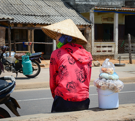 Phan Thiet, Vietnam - Oct 12, 2015. A vendor on street at the Mui Ne fishing village in Phan Thiet, Vietnam. Phan Thiet fish sauce is one of the unique tourism products.