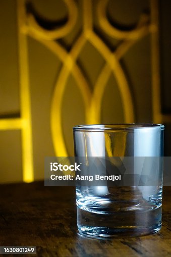 istock Empty glass on wooden table 1630801249