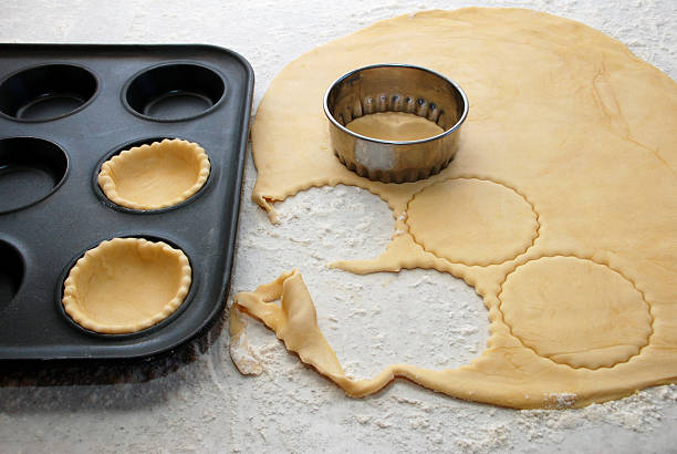 istock Pastry circles being cut and filling a bun tin 163081291