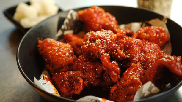 istock Soy and Spicy Korean fried chicken on a black plate. 1630814174