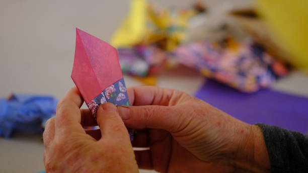 istock Hand doing Japanese origami for a colorfull paper. 1630819978