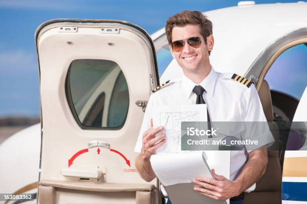 Corporate Pilot With Log Book Stock Photo - Download Image Now - Commercial Airplane, Happiness, Pilot