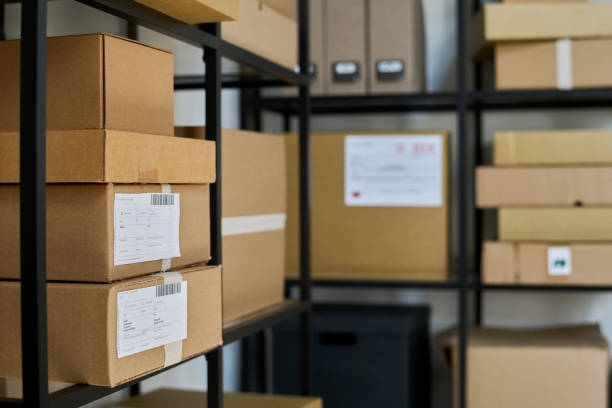 Focus on side shelf with big cardboard packed boxes containing ordered goods
