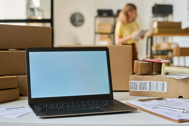 istock White screen of laptop standing on desk among packed cardboard boxes 1630839115