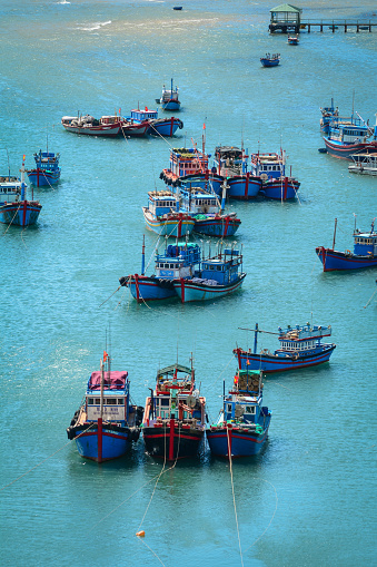 Nha Trang, Vietnam - Jan 27, 2016. Fishing boats dock on the sea in Nha Trang, Vietnam. Nha Trang is a coastal resort city in southern Vietnam known for its beaches, and offshore islands.
