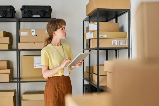 istock Young female manager with tablet checking information about ordered goods 1630842335