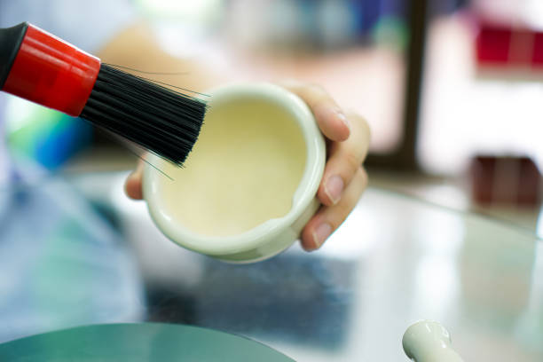 istock Picture shows a demonstration of cleaning a pill mortar using a fine-bristled brush. 1630855078