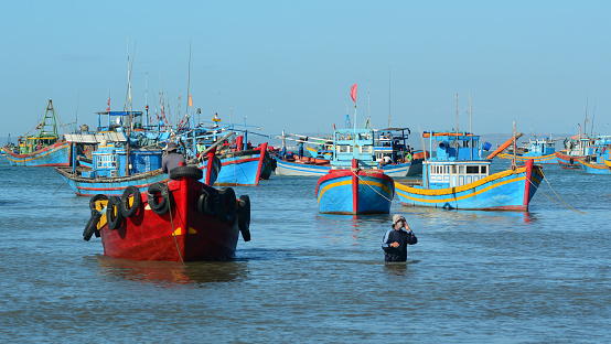 Binh Thuan, Vietnam - Jan 28, 2016. Wooden boats at Co Thach fishing pier in Binh Thuan, Vietnam. With more than 3400 km of ocean coastline, Vietnam has many fishing villages.