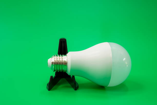 istock Image of an energy-efficient white LED bulb on a green background. 1630880737