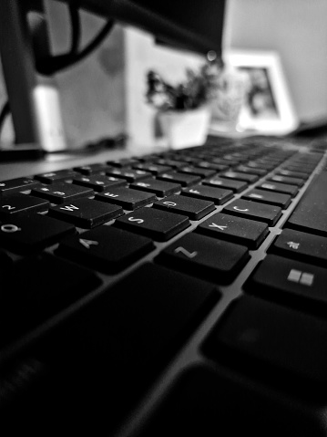 B&W closeup of a wireless dell keyboard in home office