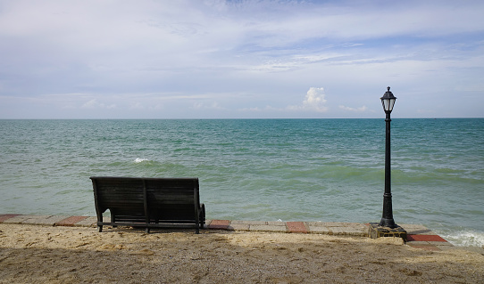 Seaside park with chair and lamp post at sunny day in Mui Ne town, Vietnam.