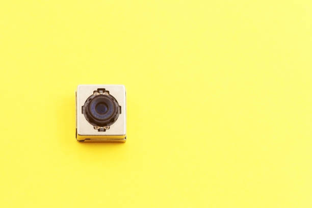istock A miniature digital camera of a mobile phone on a yellow background 1630920062