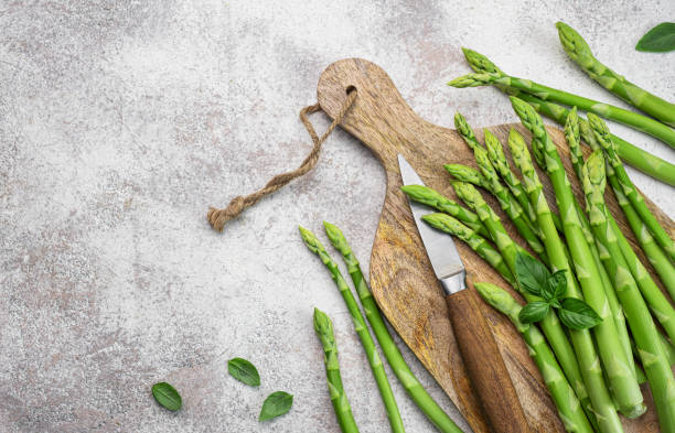 istock Fresh green asparagus on  concrete background. 1630936261