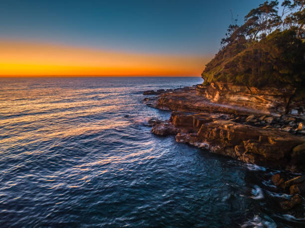 istock Sunrise over the ocean with orange horizon 1630955064