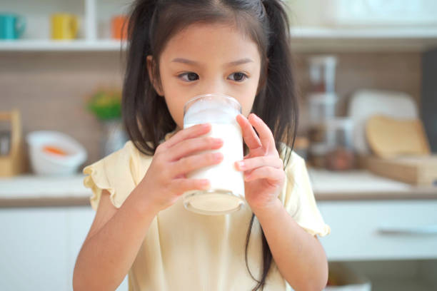 istock Little cute girl drinking a milk 1630960484