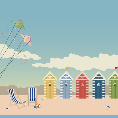Beach scene with pretty beach huts, a seagull, two kites and a couple of deckchairs.
