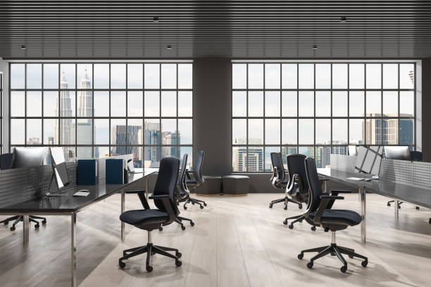 istock Stylish coworking interior with pc computer and armchairs in row, window 1630976058