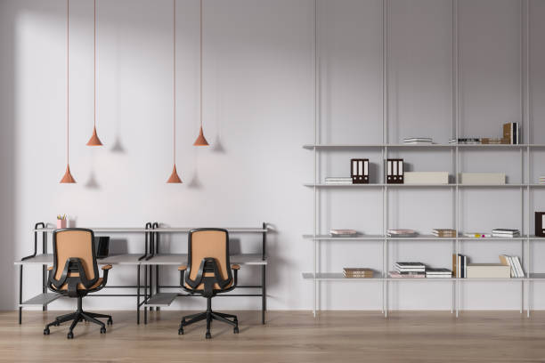 istock Educational interior with table and armchairs, shelf and books 1630985687