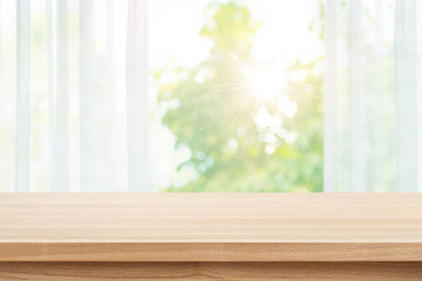 istock Empty wood table top on blur curtained autumn window background 1630988420