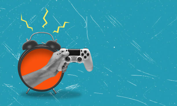 istock Art collage, hands with a gaming joystick emerging from an alarm clock on a blue background with space for advertising. Time for entertainment. 1630994252
