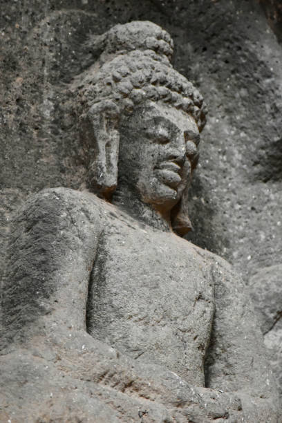 Close Up Detail of Buddha Sculpture on a upper side at the entrance of Chaitya Hall, Karla Buddhist Caves, these Caves was constructed between 50 and 70 CE, and 120 CE, located near the Karla, Lonavala in Pune Dist. Maharashtra, India. detalle de cerca de la escultura de buda en una parte superior en la entrada de chaitya hall, karla buddhist caves, estas cuevas fueron construidas entre 50 y 70 ce, y 120 ce, ubicadas cerca de karla, lonavala en pune dist. maharashtra, india.