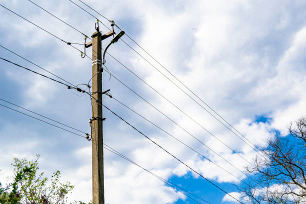 istock Power electric pole with line wire on colored background close up 1630997113