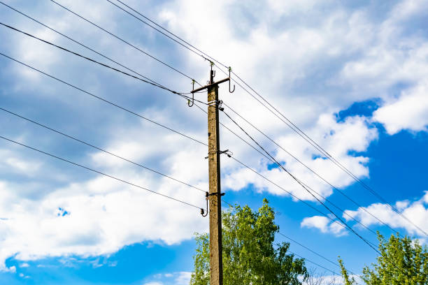 istock Power electric pole with line wire on colored background close up 1630997389