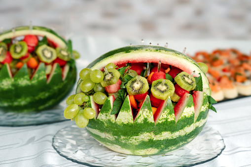 Creative fruit bowl made of watermelon at outdoor catering event, creativity concept